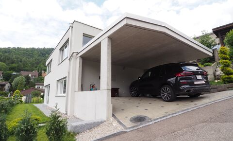 Modern single-family house with double carport on an elevated panorami