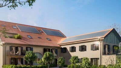 a large house with solar panels on the roof