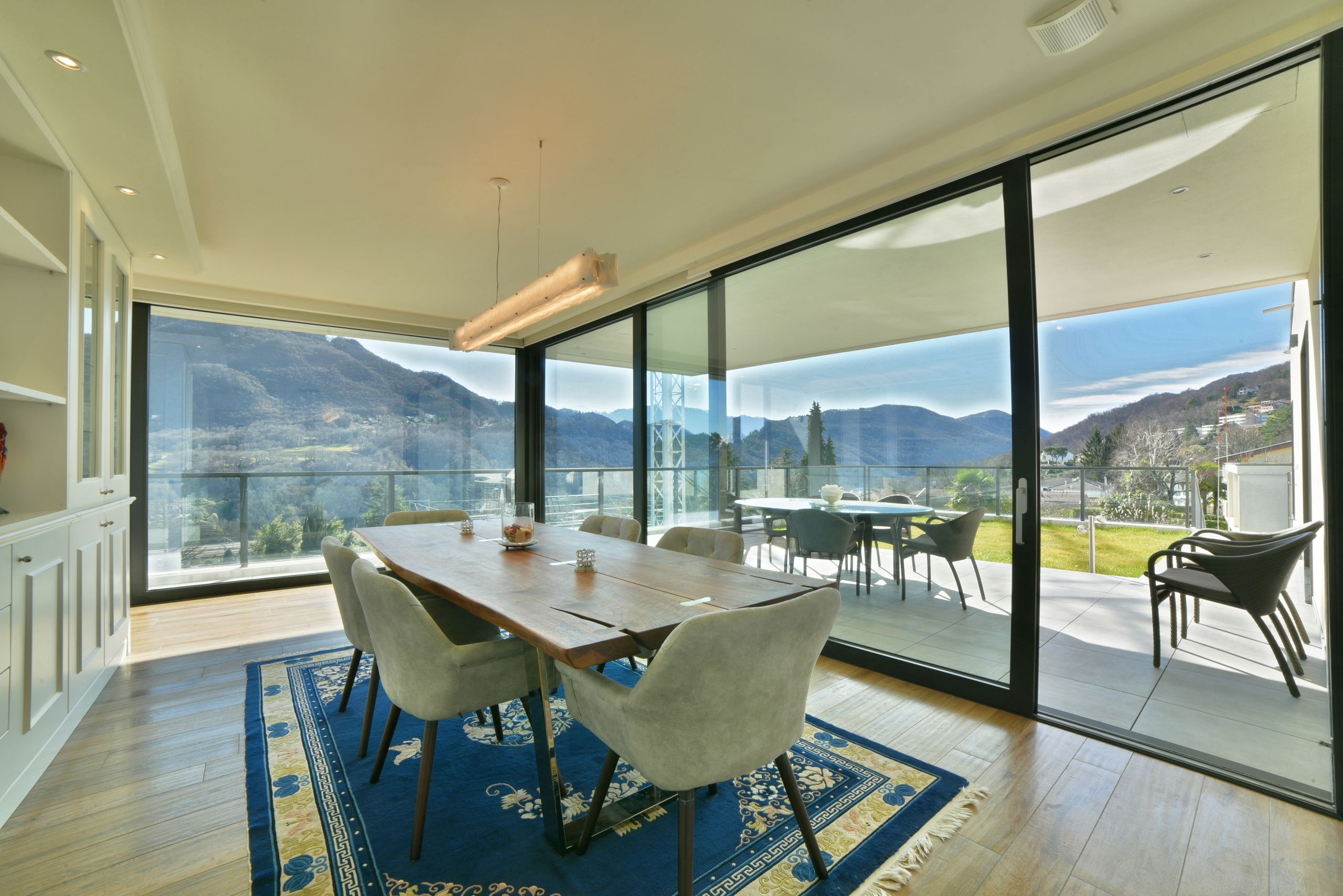 In Montagnola (Collina d'Oro), in a prestigious very quiet and sunny residential area , 4 km from the center of Lugano and only 450 meters from the American school TASIS, we offer for sale this ultra modern luxury villa with beautiful panoramic view of lake Lugano and surrounding mountains.

Built in 2018 with high quality materials and luxury finishes, the villa features 6 bedrooms, 8 bathrooms, large covered terrace (summer lounge) with flat garden, SPA area with heated indoor pool, fitness room, sauna, hammam, Whirlpool and a large garage for 4 cars.

The villa with a total area of ​​approx. 680 m2 is arranged on 2 levels as follows:

UPPER FLOOR:
Graceful entrance hall, living room with large floor-to-ceiling windows and magnificent panoramic views of the surrounding mountains, dining room, exit to the covered terrace (summer lounge) and flat garden; kitchen with dining room, guest WC; 2 single bedrooms with en-suite bathrooms, hobby room; master bedroom with walk-in closet, en-suite bathroom and exit to the garden; office / bedroom, bathroom, 2 walk-in closets.

GROUND FLOOR:
Two-room apartment with independent entrance (living room with kitchen, bedroom with en-suite bathroom); personnel / guest room, bathroom, rack room, laundry; home cinema; Wellness area with heated swimming pool, whirlpool, sauna, hammam, fitness room, shower, bathroom, changing room, technical room; 100 sqm garage for 4 cars, 2 outdoor parking spaces.

The villa uses alternative energy sources and is equipped with a latest generation home automation system, air conditioning and alarm system.

Heating: classic electric heat pump + geothermal heating as a help (about 12 degrees). There are 5 geothermal probes that go to the depth of 140 meters and which allow a circulation of warmer water in the floor coils.

There is an underground tank of 10'000 liters for the irrigation of the lawn, completely managed by home automation, therefore also remotely.

There is a heat pump for cooling, which in summer helps to lower the internal temperature of the house by 5/6 degrees, without the need to use air conditioning.