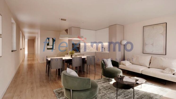 a living room and kitchen in a modern apartment with white furniture