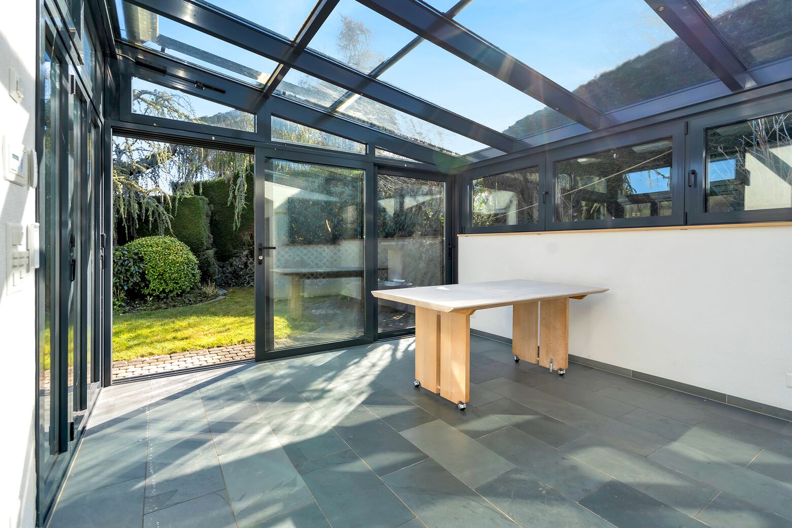 Grosser Wintergarten mit direktem Zugang zum Garten