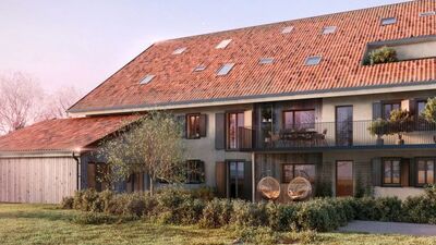 a large home with a sloping roof and a balcony
