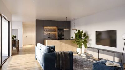 a modern apartment with hardwood floors, a large living room with a blue couch, a tv, and a table with a plant plant on it
