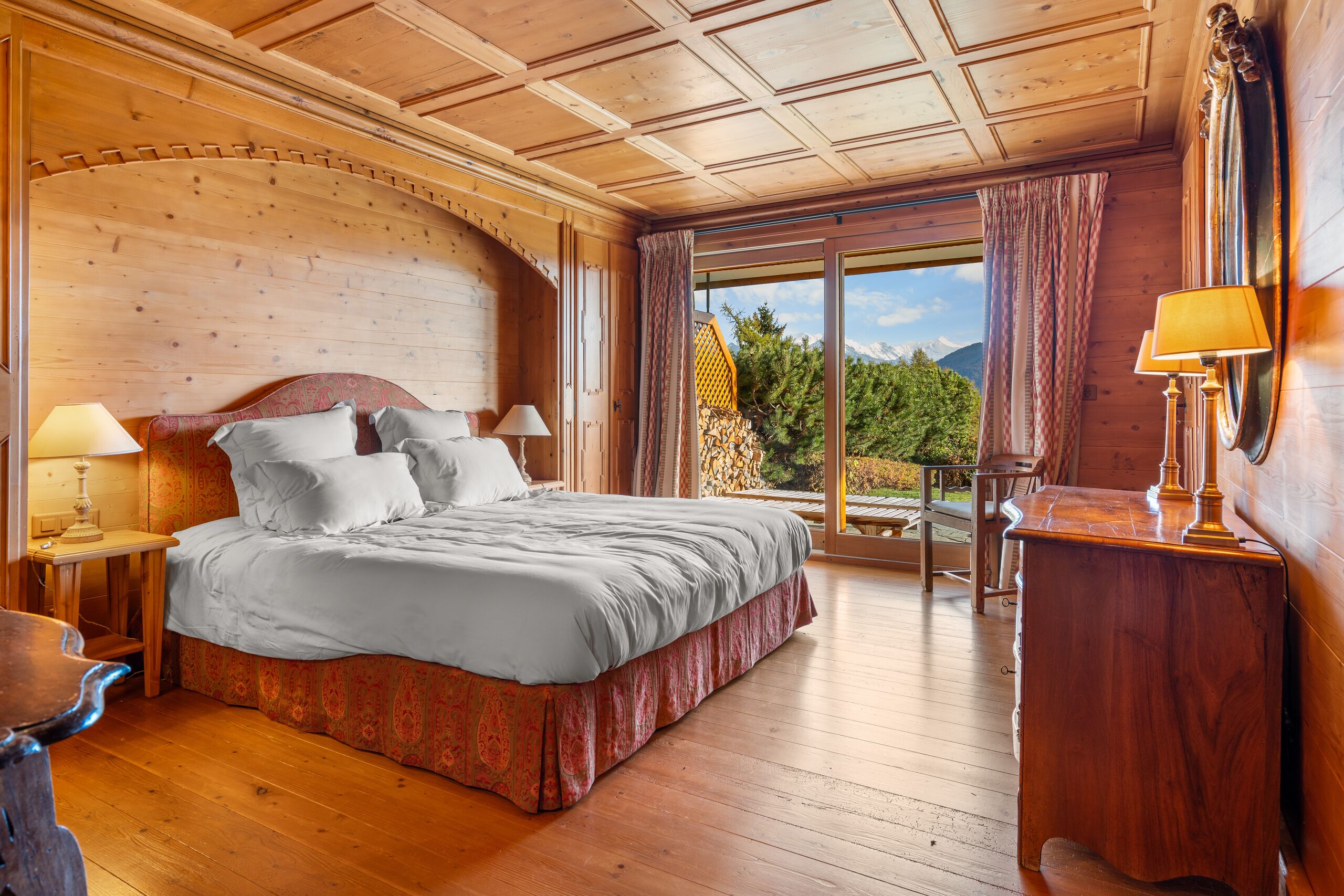 a large bed in a room with wooden walls