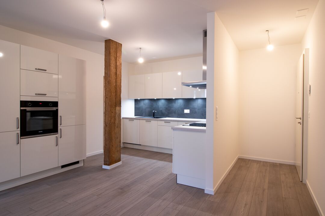Rénovation d'une ferme du 19e siècle en 15 appartements à Roche : l'intérieur.