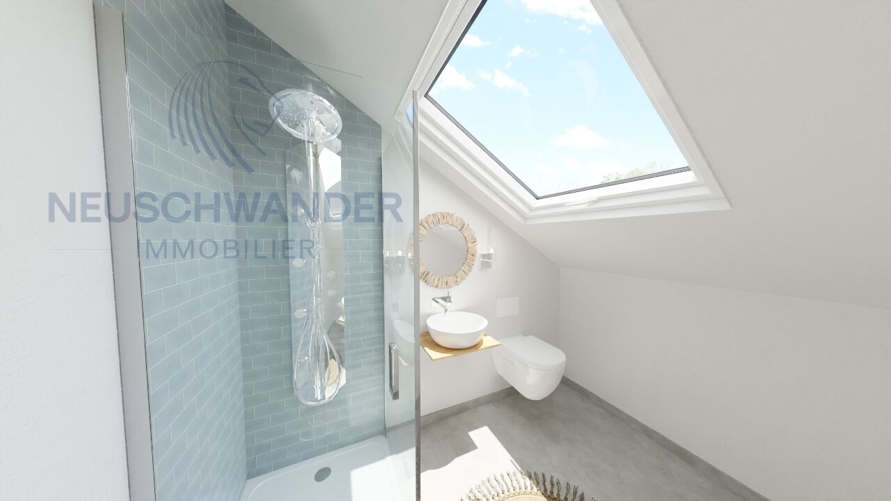 une petite salle de bains avec une lucarne, des toilettes blanches et une douche aux murs bleus