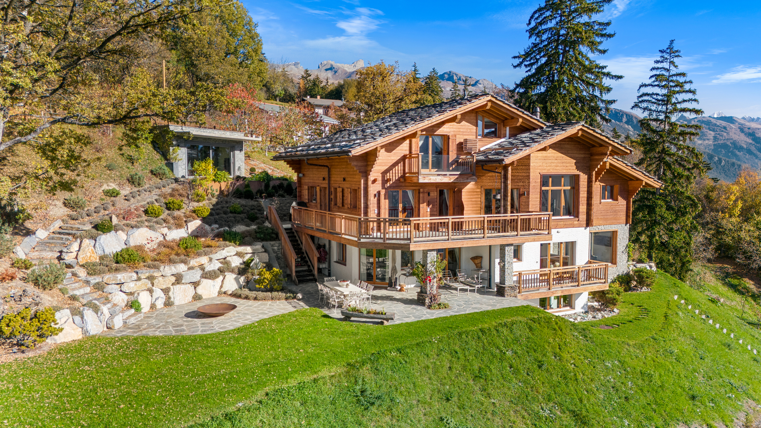 a wooden home on a hill in the mountains