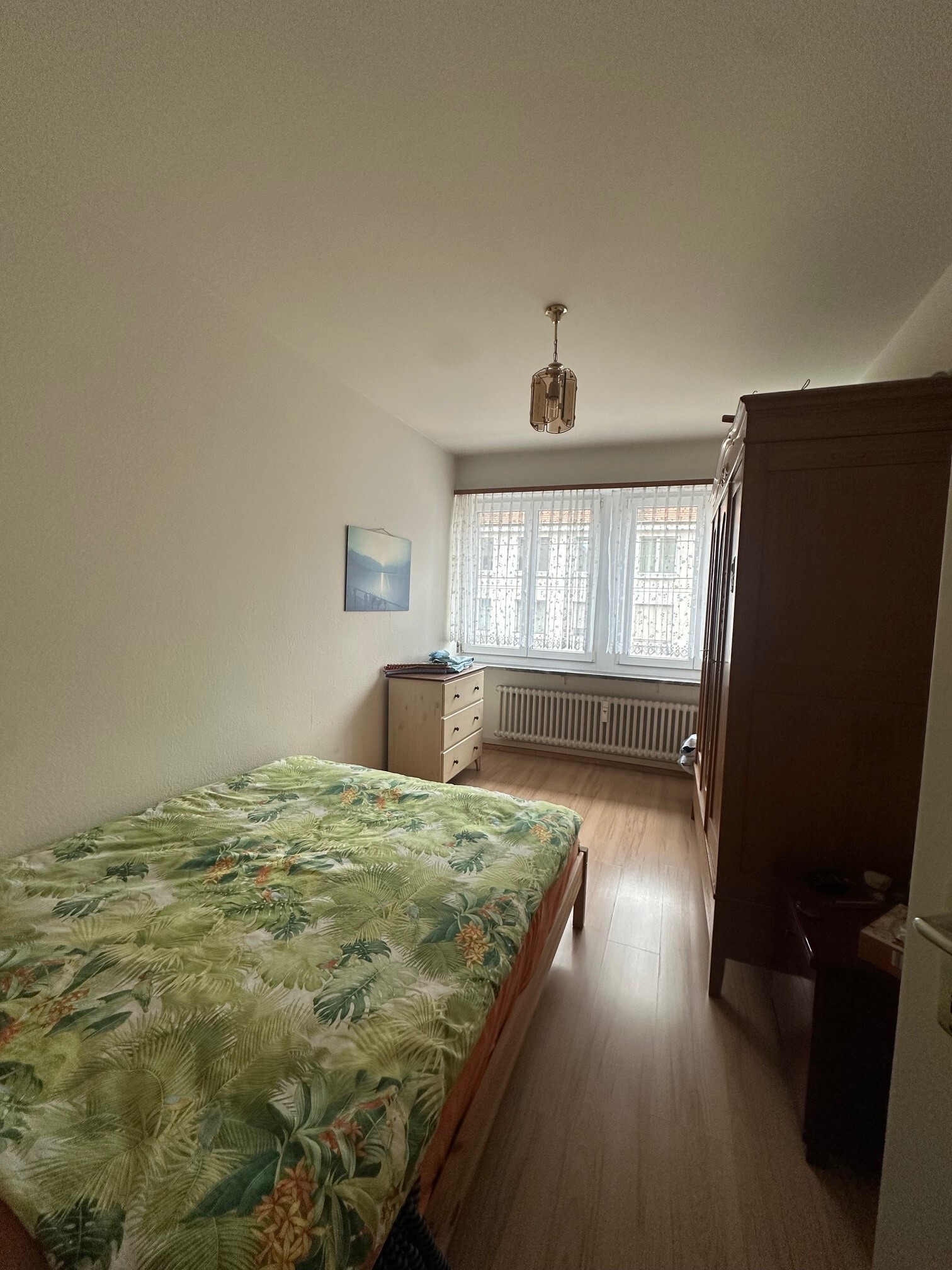 a bedroom with a large bed and a dresser