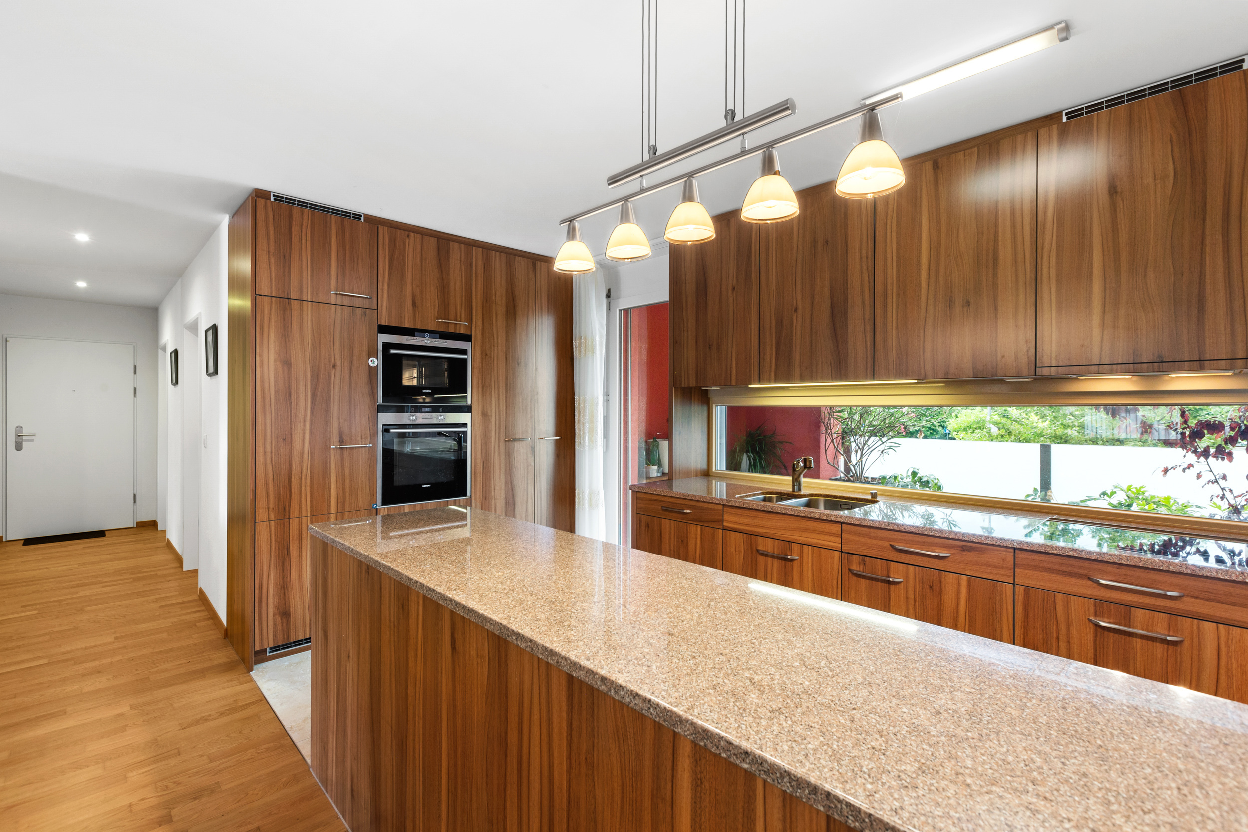 Die offene Küche überzeugt mit reichlich Licht, Qualität und direktem Zugang zum Balkon.