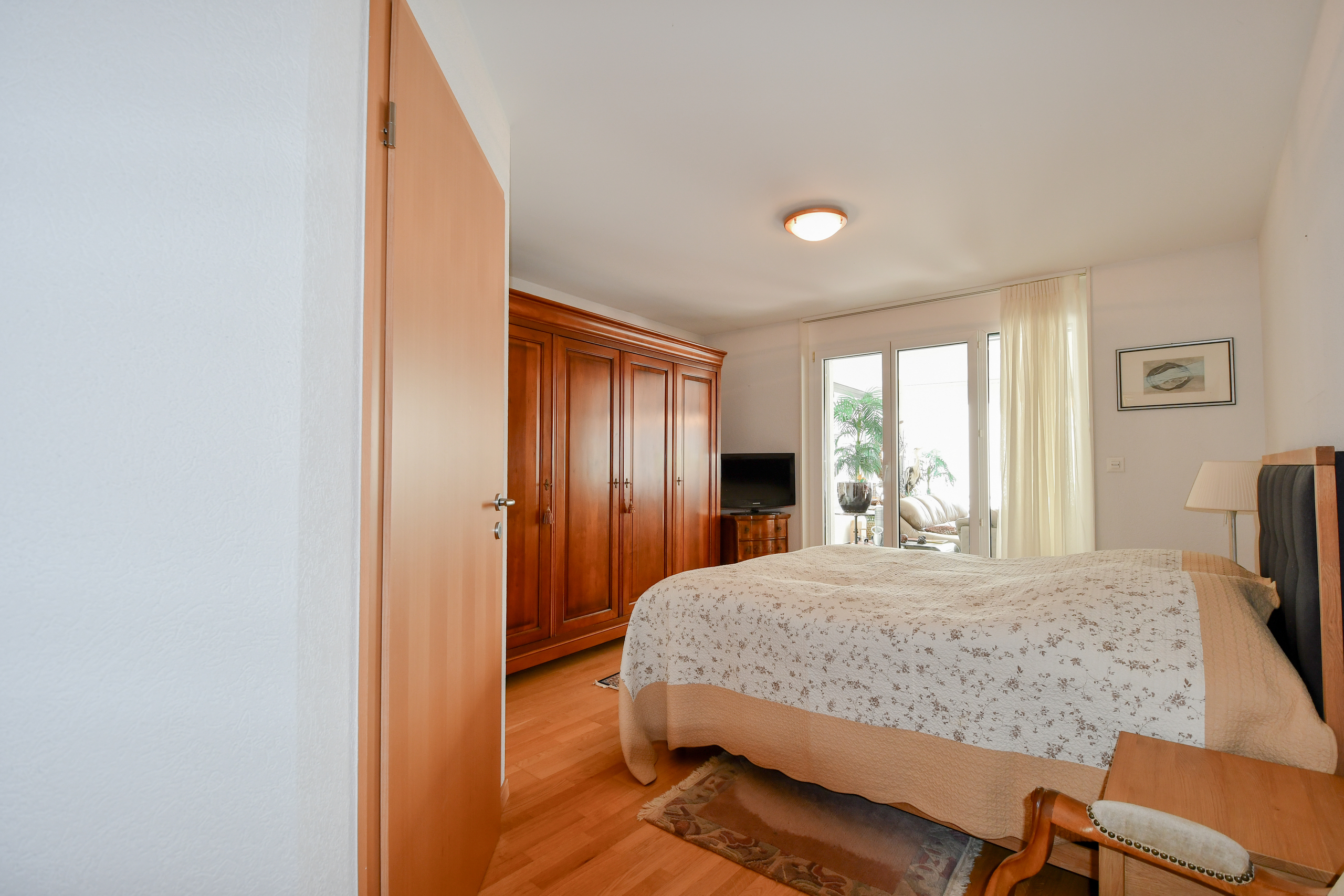 a bedroom with a large bed and a door to the bathroom