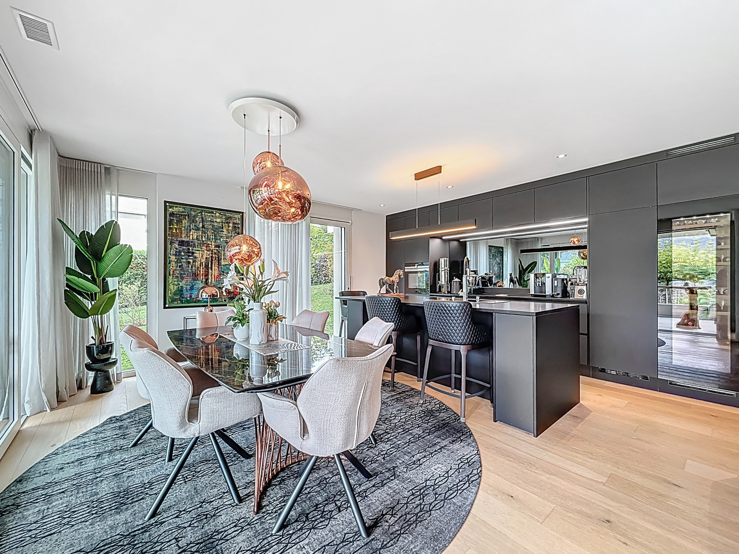 a modern home with a large dining area with a table and chairs a modern home with a large dining area with a table and chairs