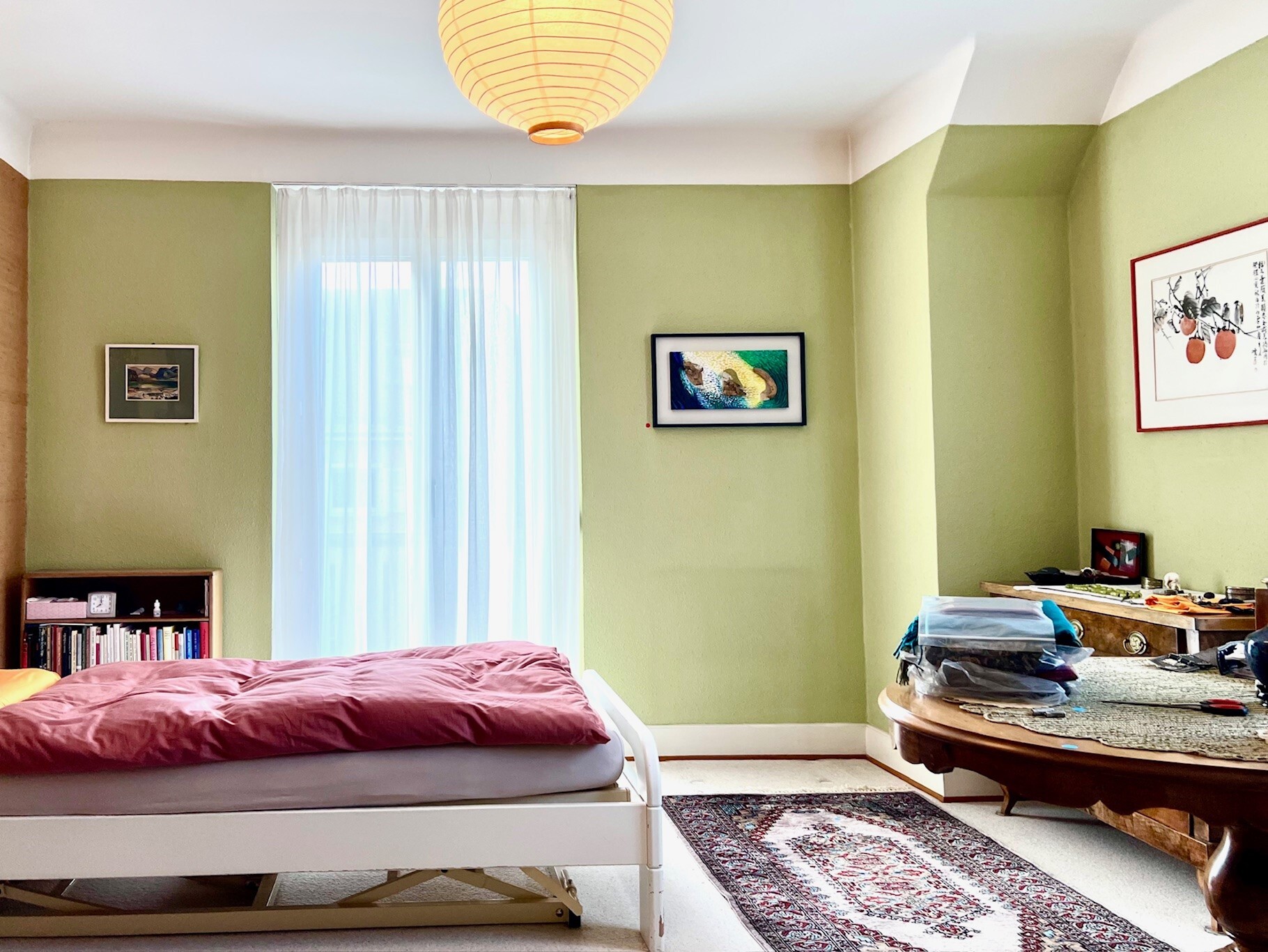 a bedroom with green walls and a white bed