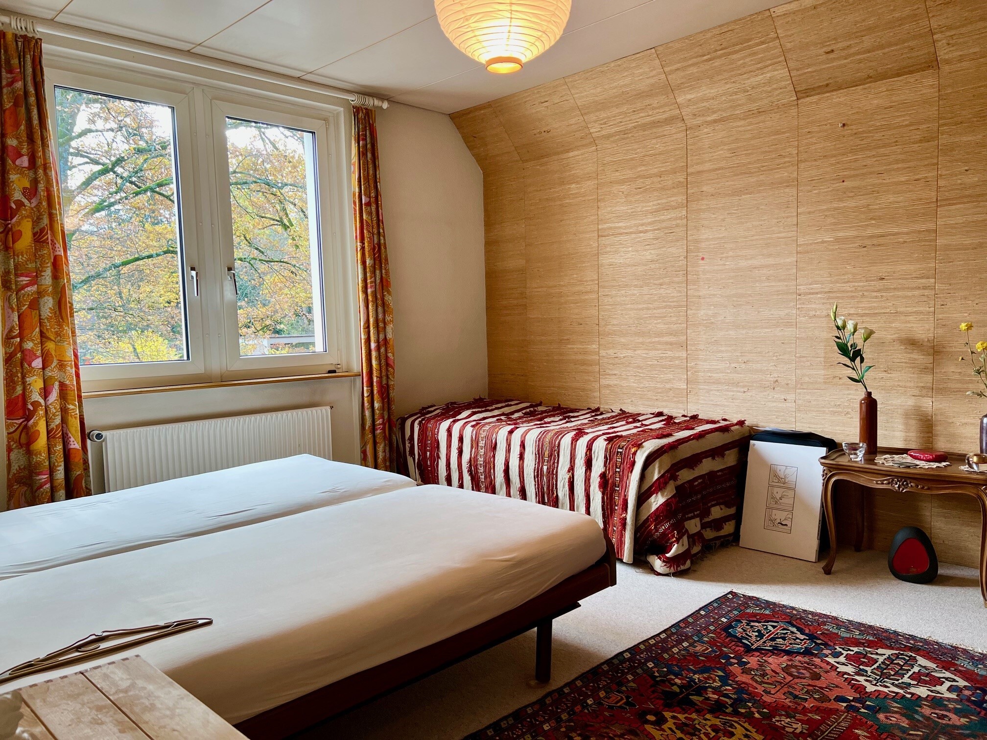 a room with a double bed and a large window