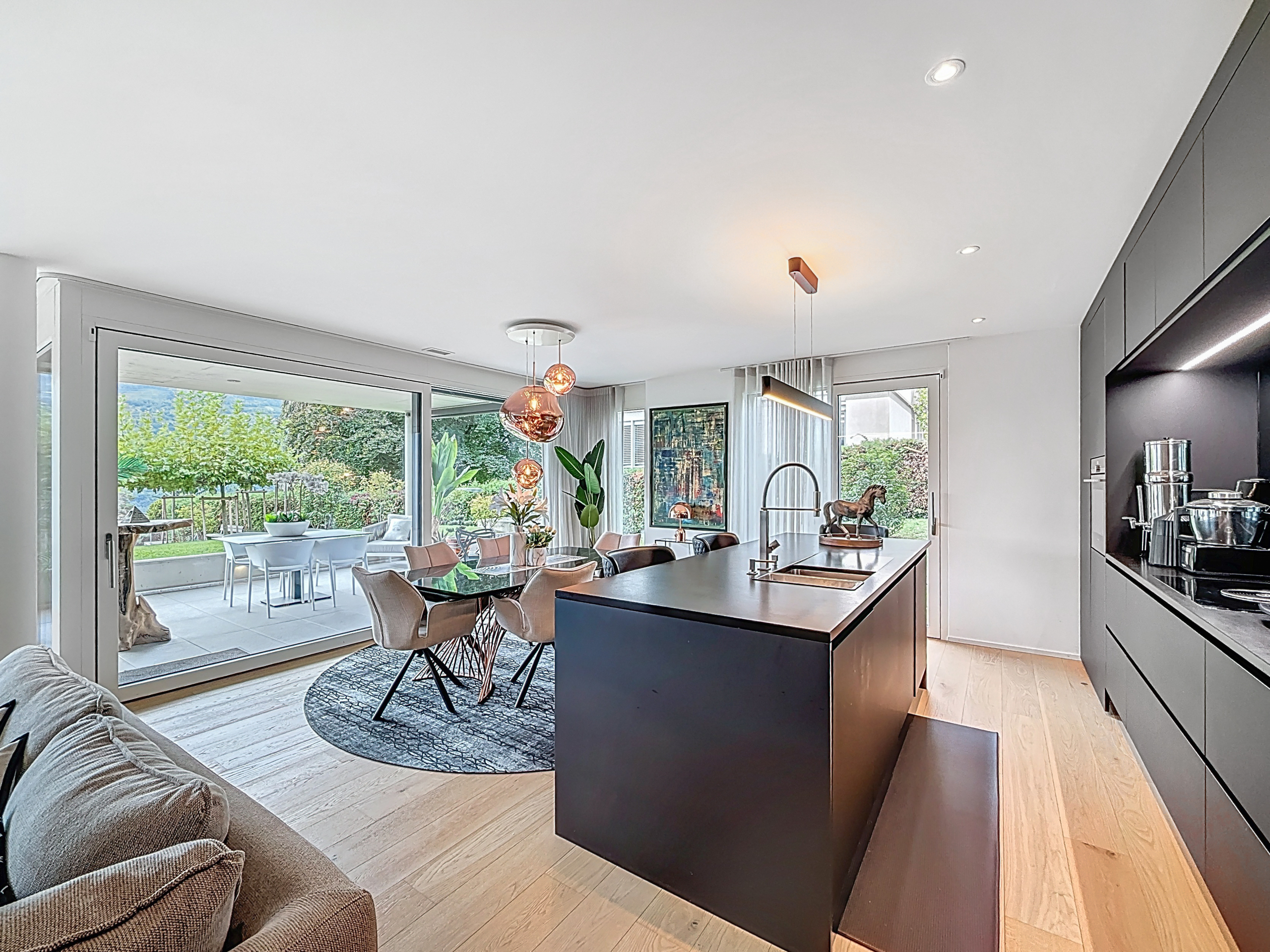 the kitchen and living room of a modern apartment with large windows the kitchen and living room of a modern apartment with large windows
