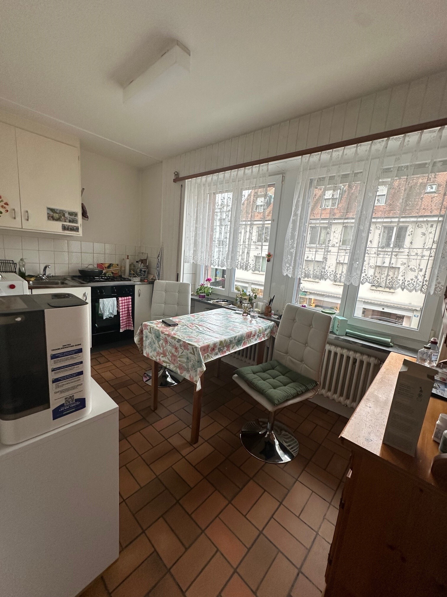 a small room with a table and chairs and a large window