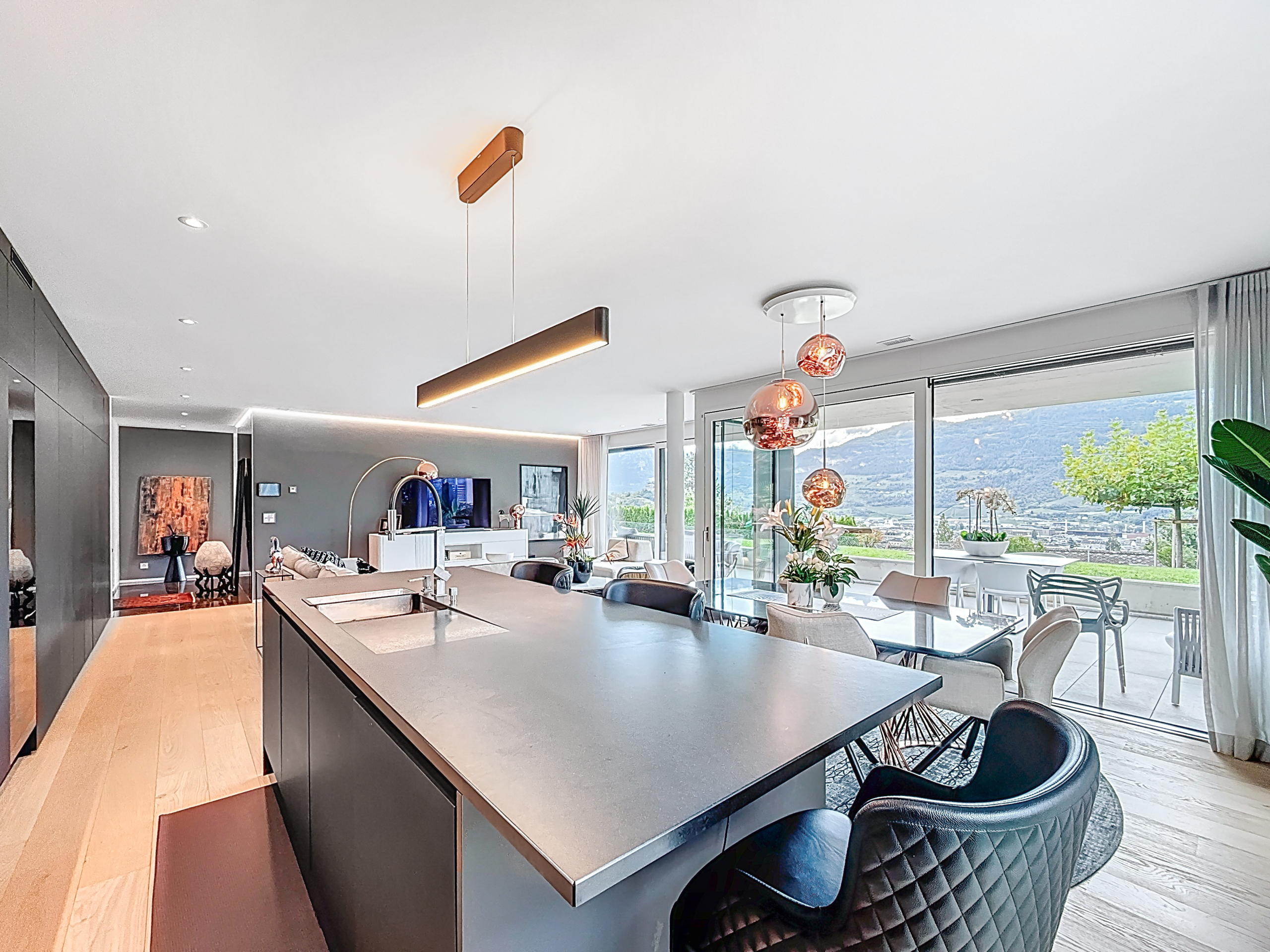 this is a picture of an open kitchen, dining room and living room in a modern apartment this is a picture of an open kitchen, dining room and living room in a modern apartment