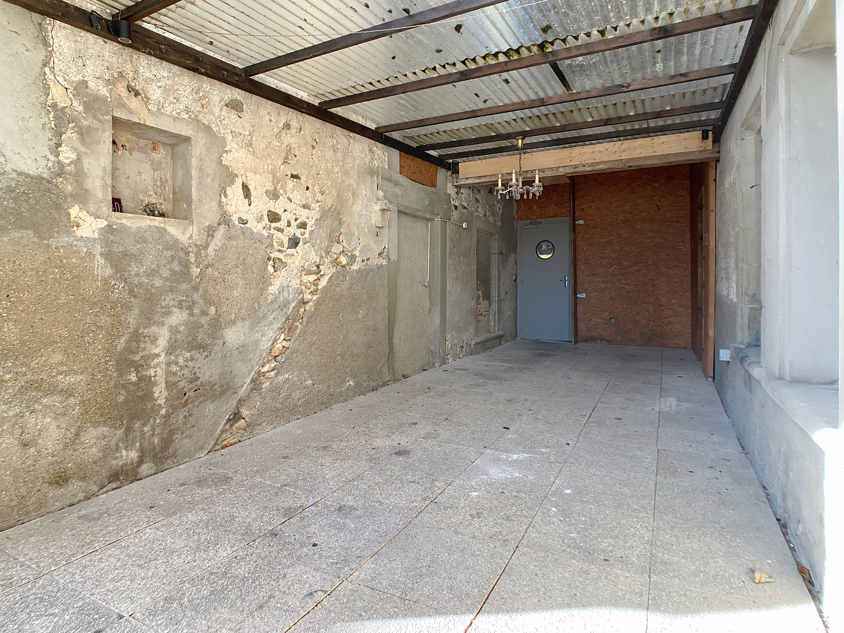 Terrasse couverte devant l'entrée et accès au jardin