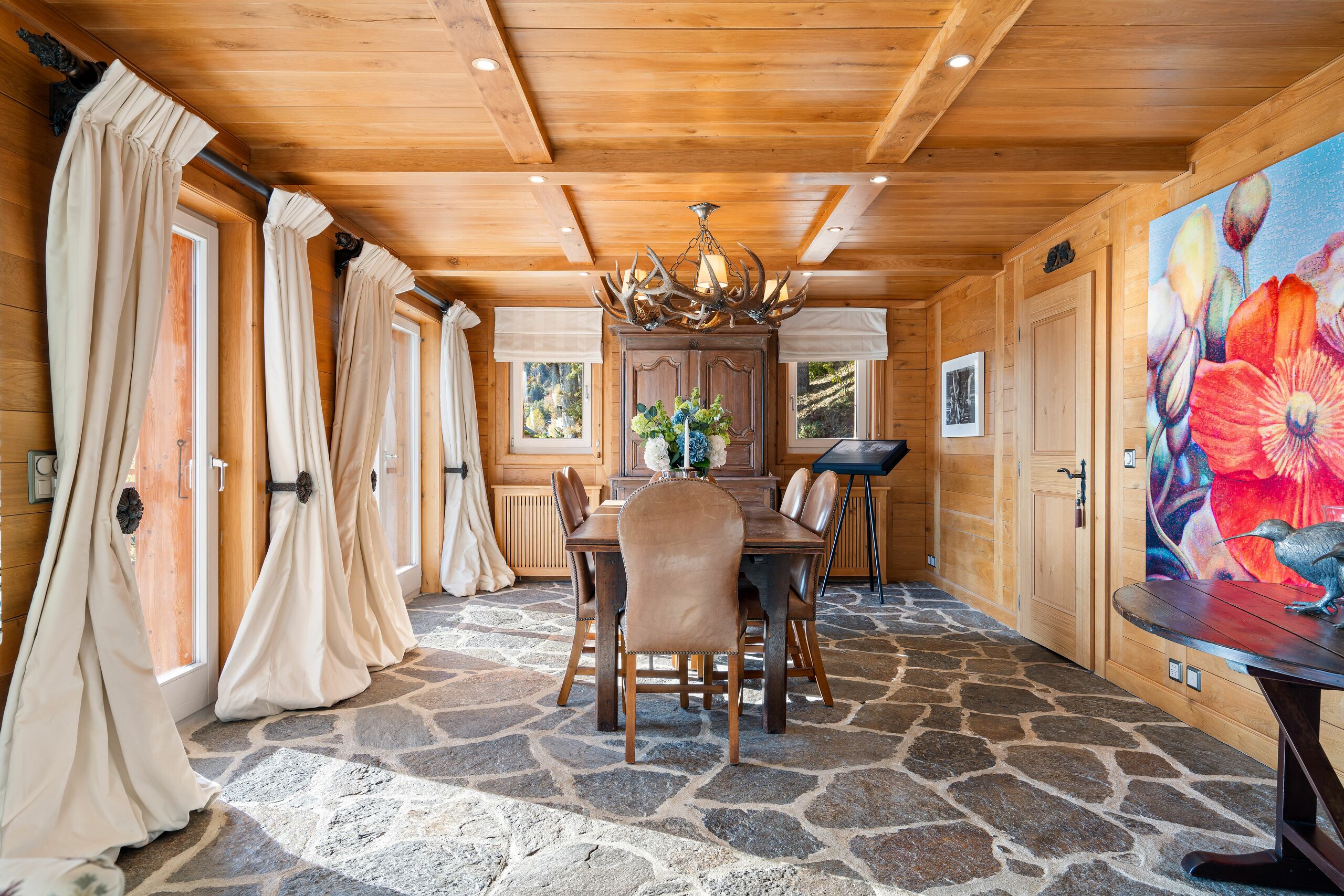 the interior of a home with wood paneled walls and a large dining room