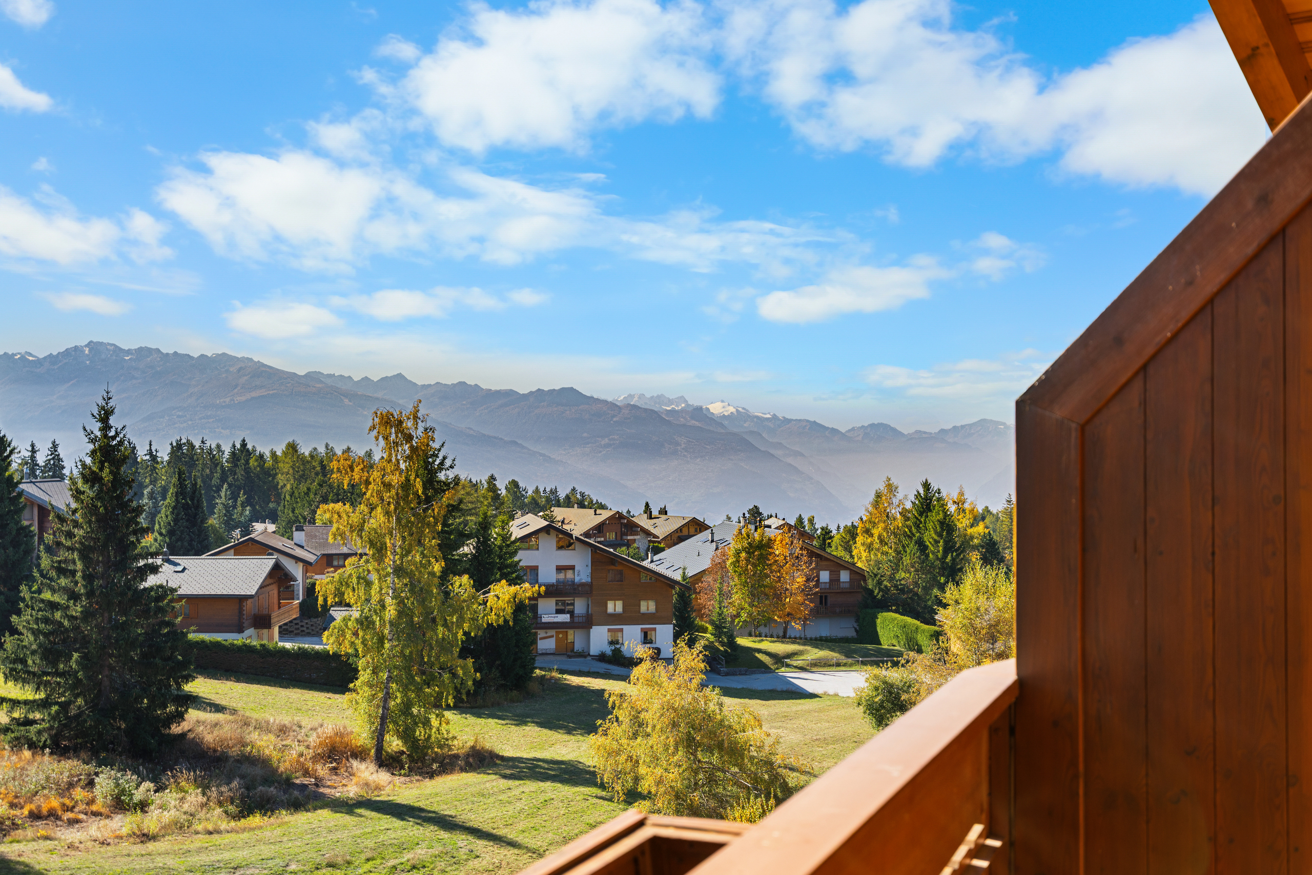 a view of the mountains from the deck of a home