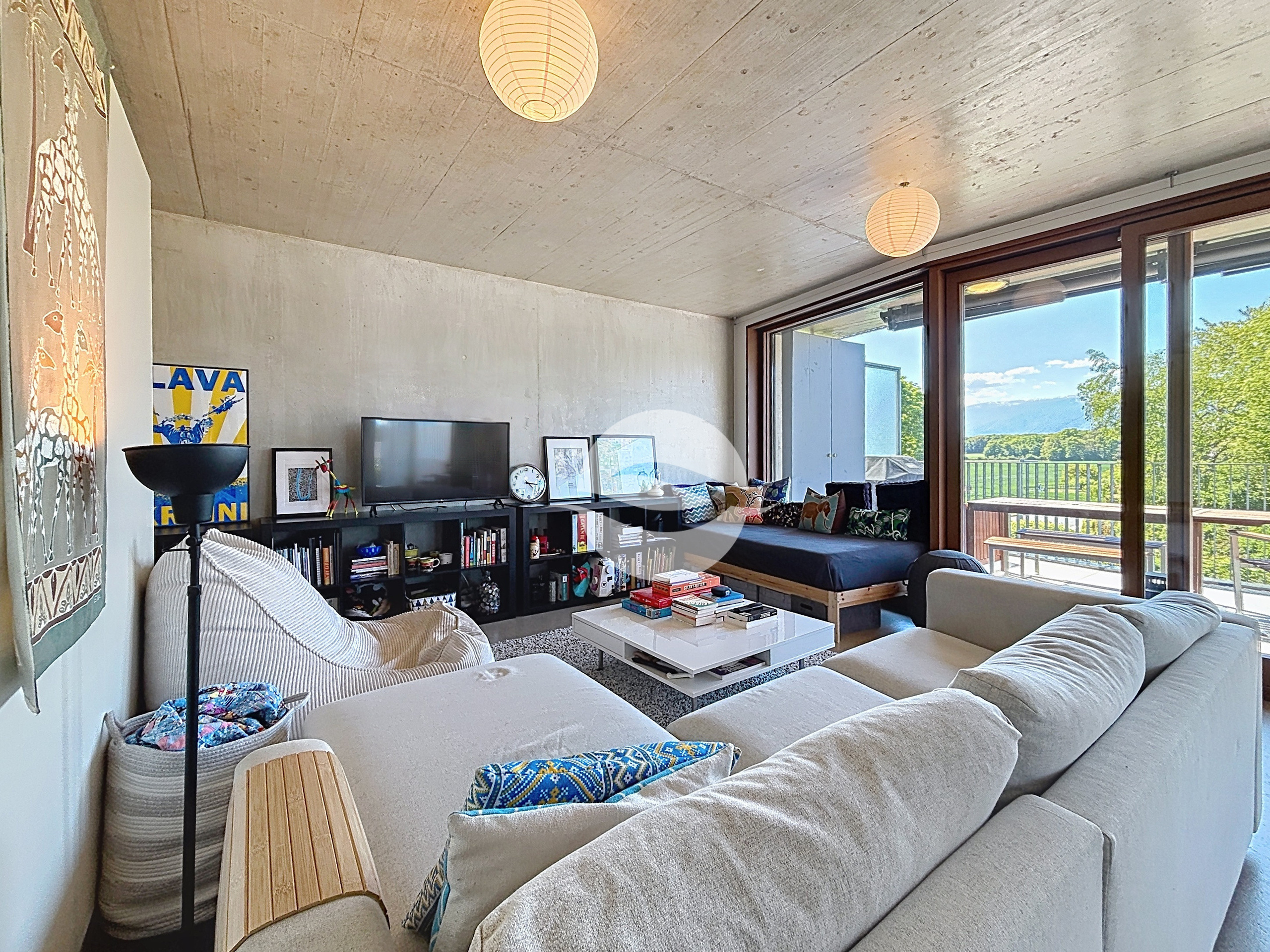 Spacieux séjour/salle à manger baigné de lumière grâce à de grandes baies vitrées, ouvrant sur une terrasse