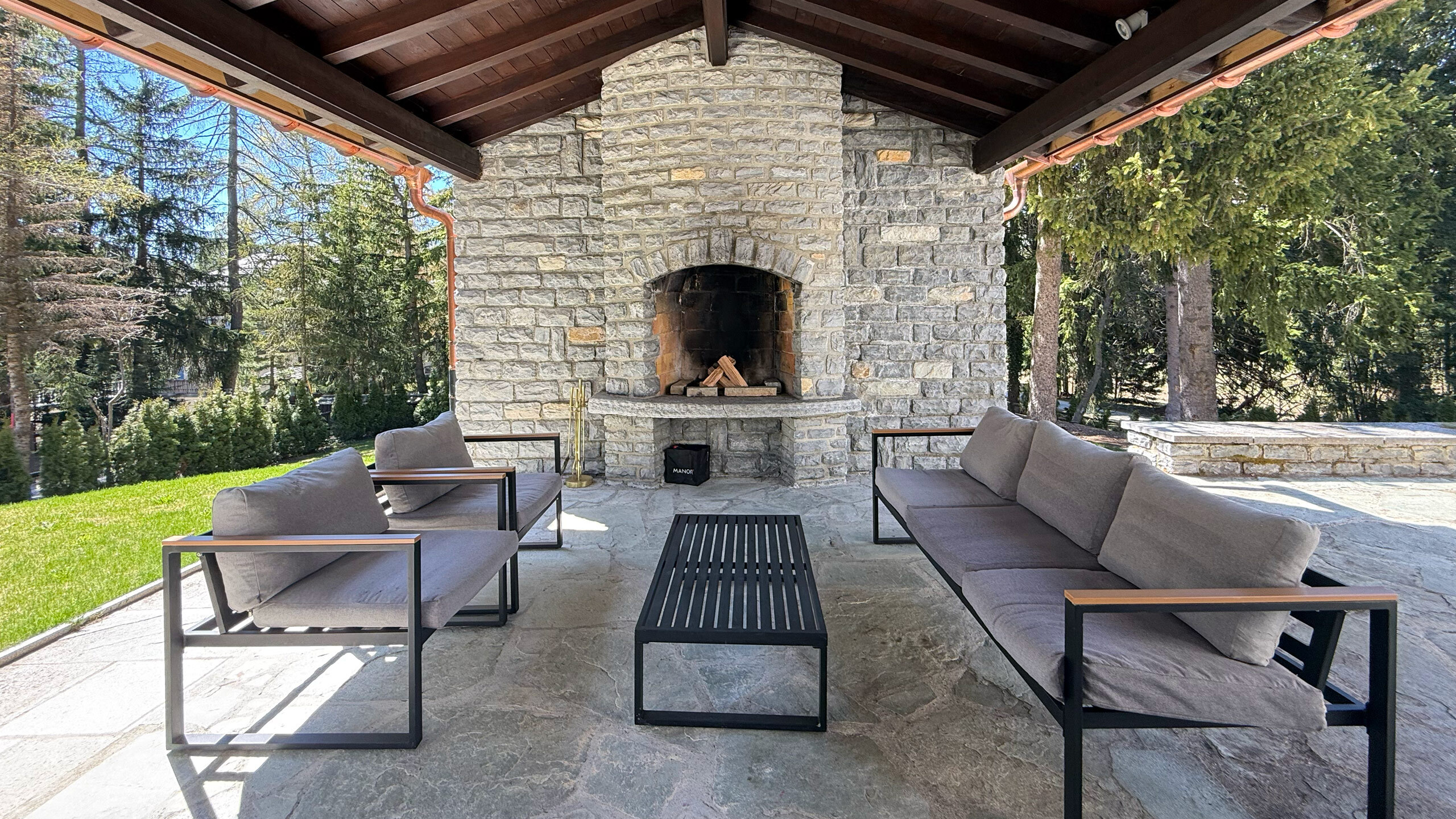 Covered outdoor area with wood-burning fireplace