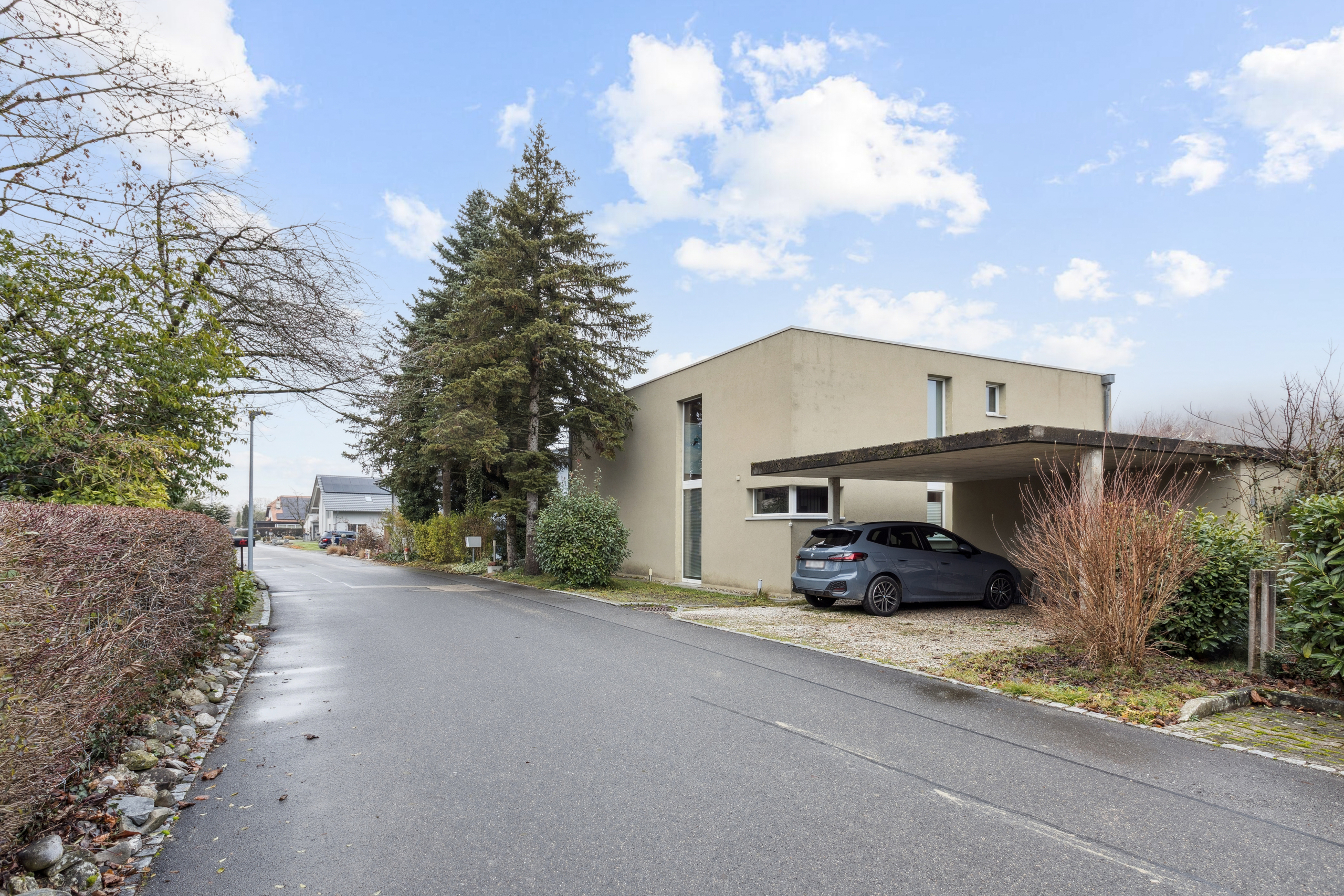 The modern house with three outdoor parking spaces