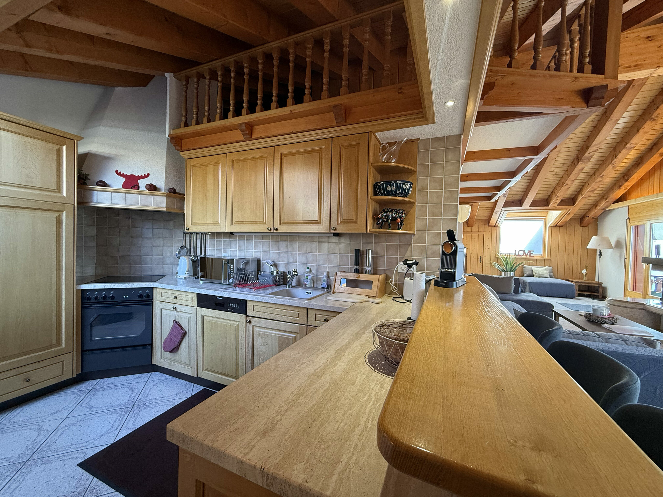 Kitchen and bar, separating the living room from the dining room Kitchen and bar, separating the living room from the dining room