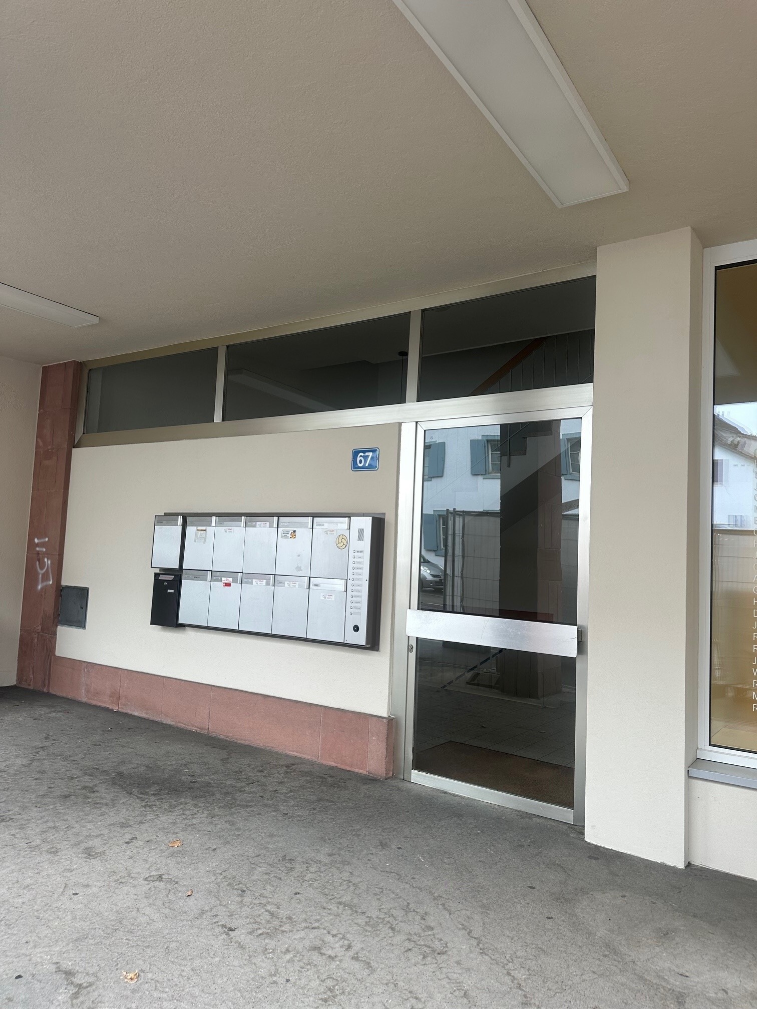 an empty room with large windows and doors