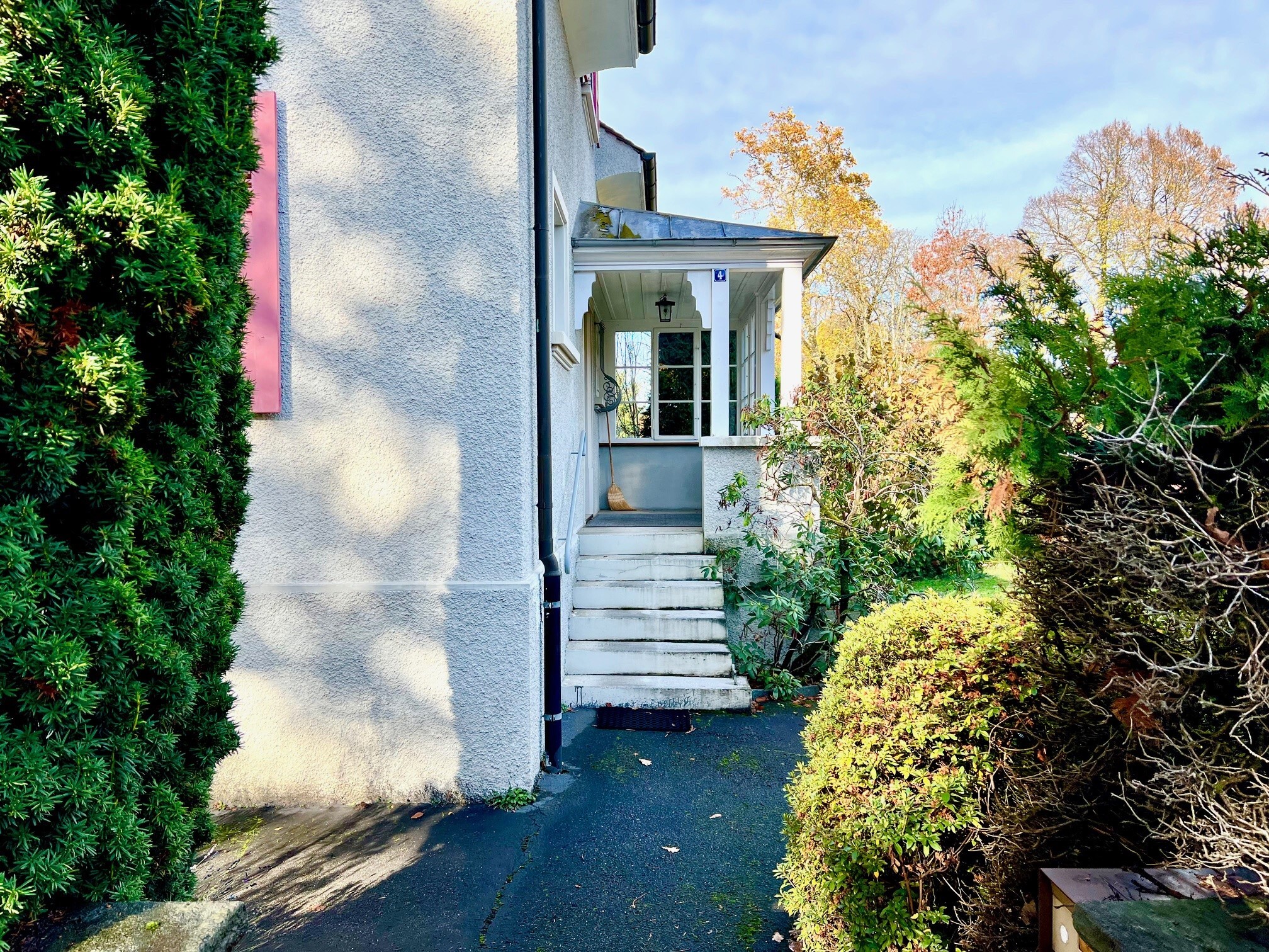 a white house with steps leading up to the entrance