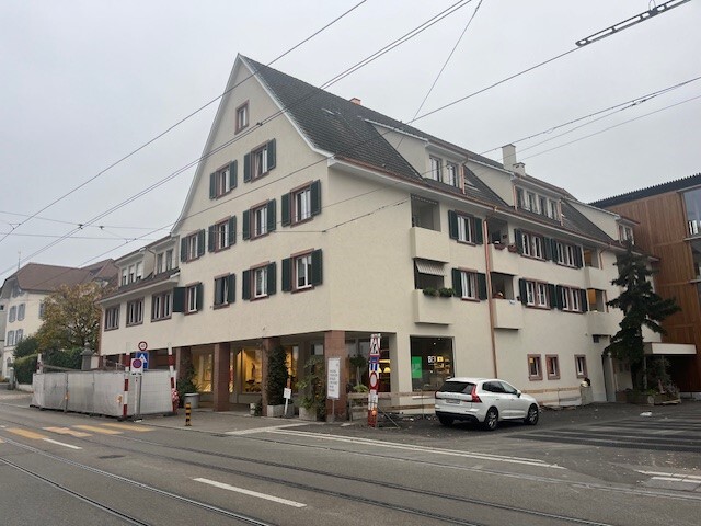 a large white building on the side of a street