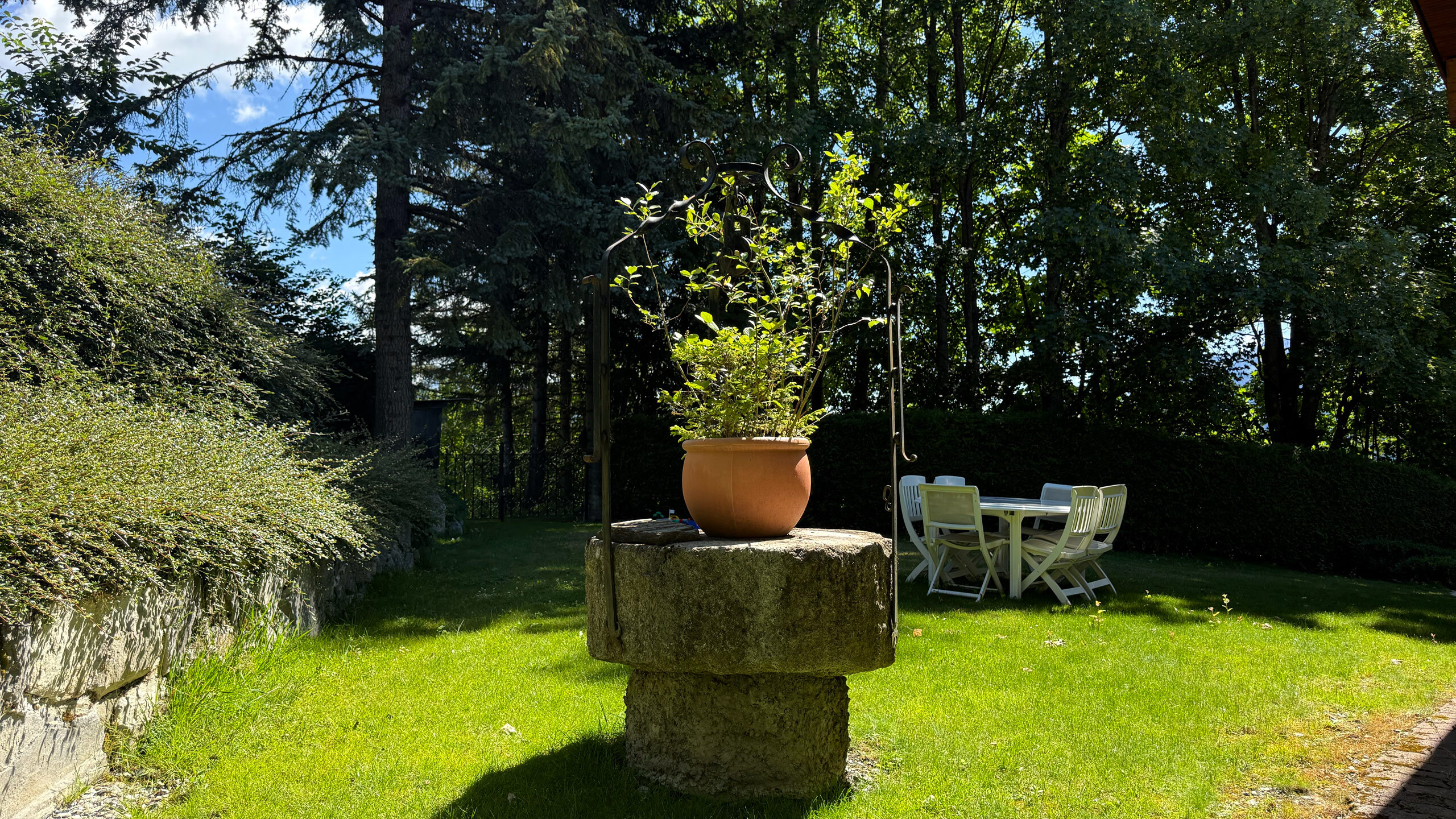 Stone well and garden area Stone well and garden area