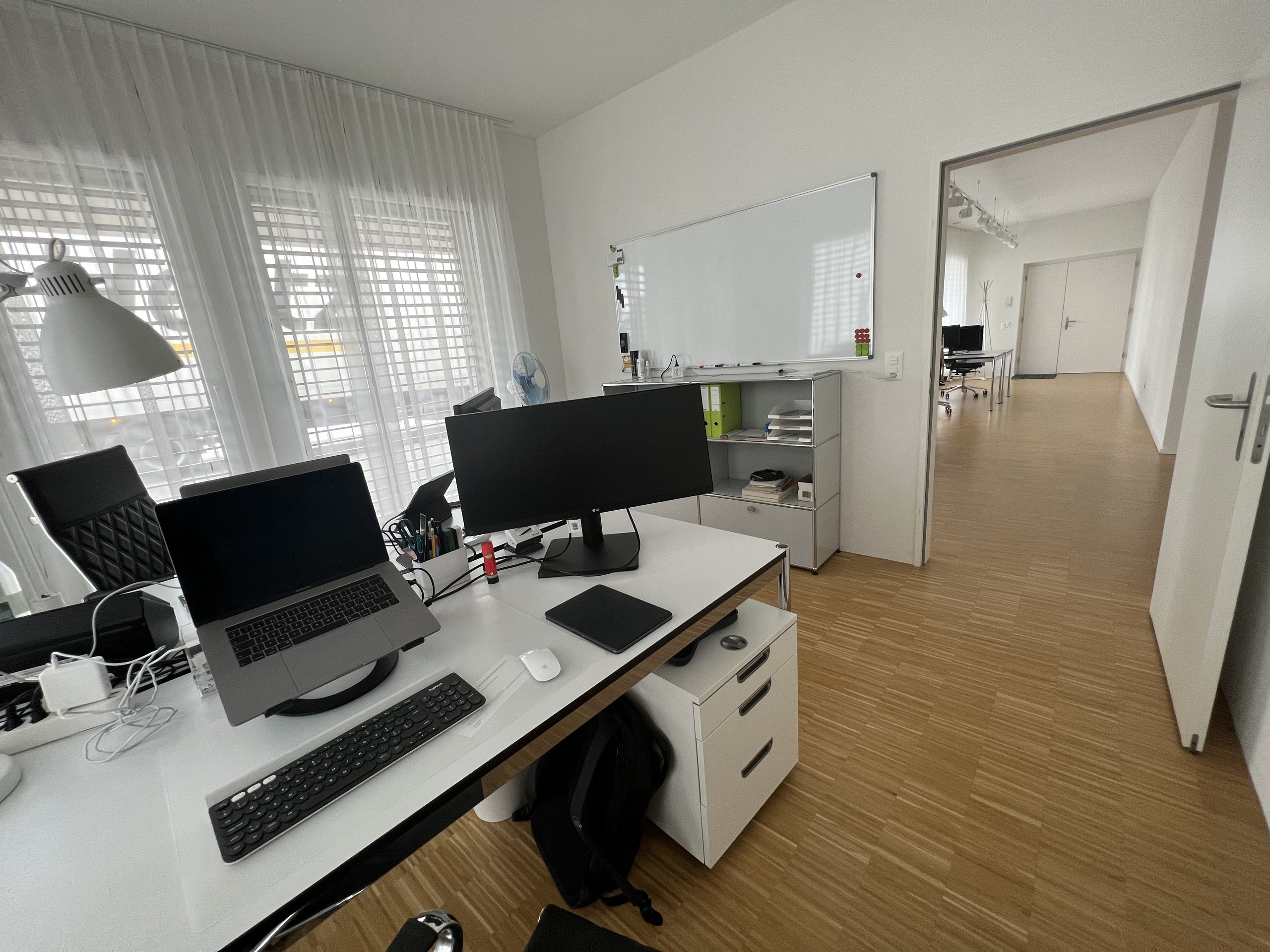Durchblick von Büro (Eckraum) durch Grossraumbüro zu Eingangstüre